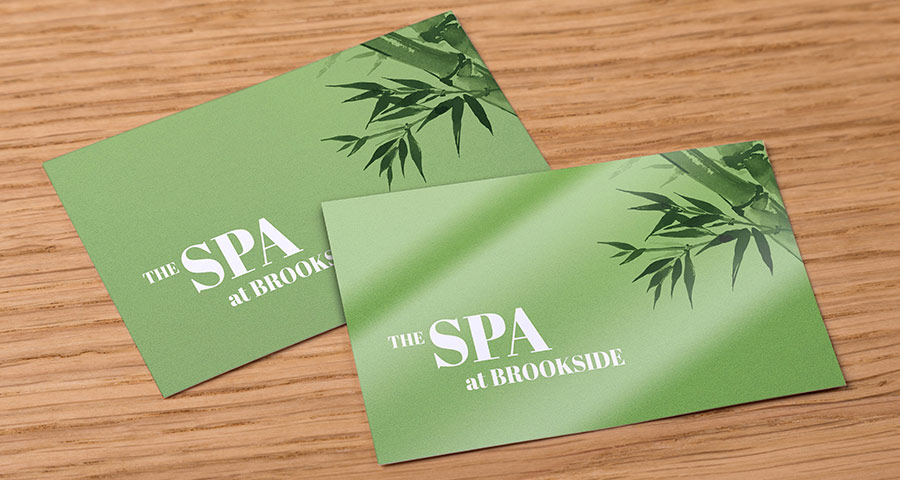 Green spa business cards on a desk